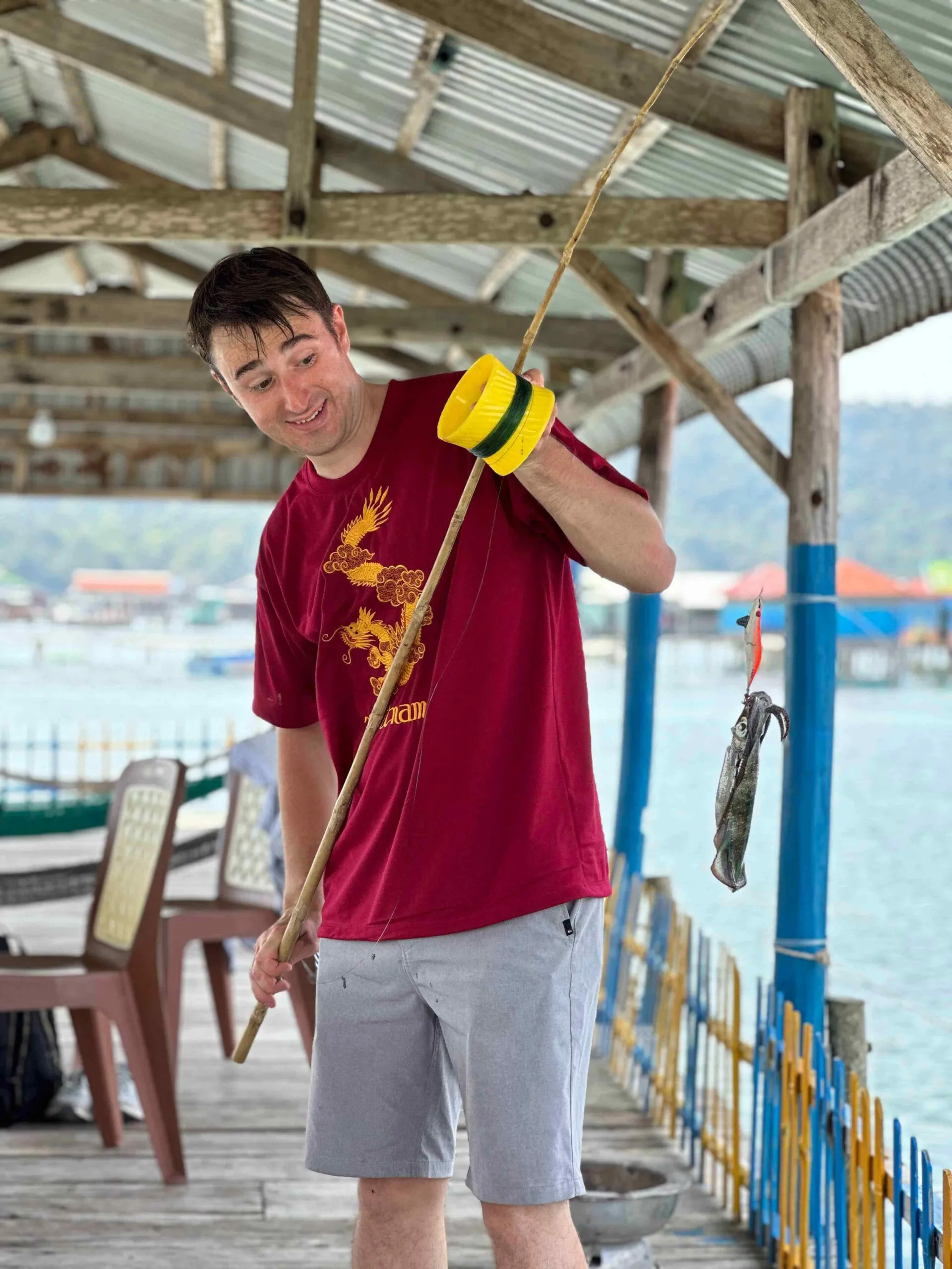 a man holding a caught fish