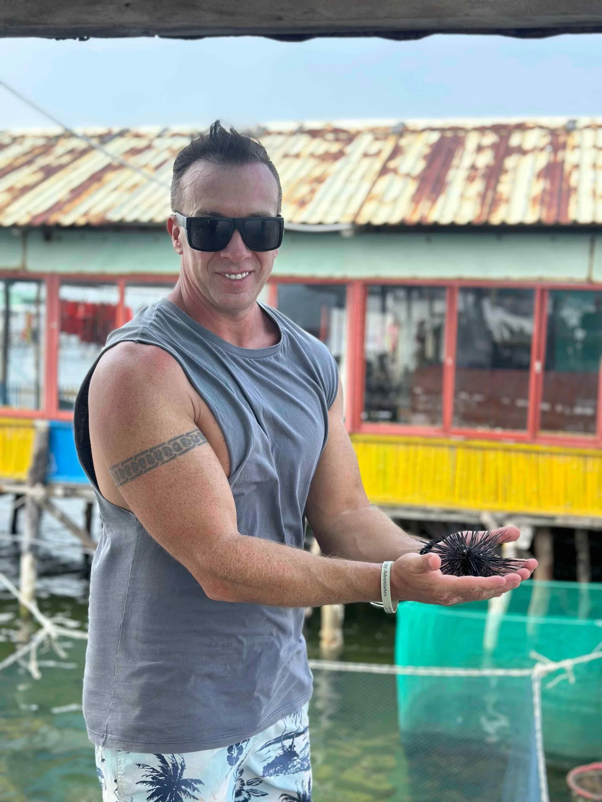 a man posing with a sea urchin