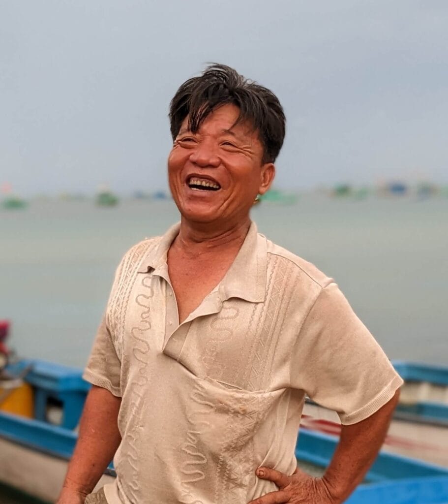 A man smiling at a floating restaurant