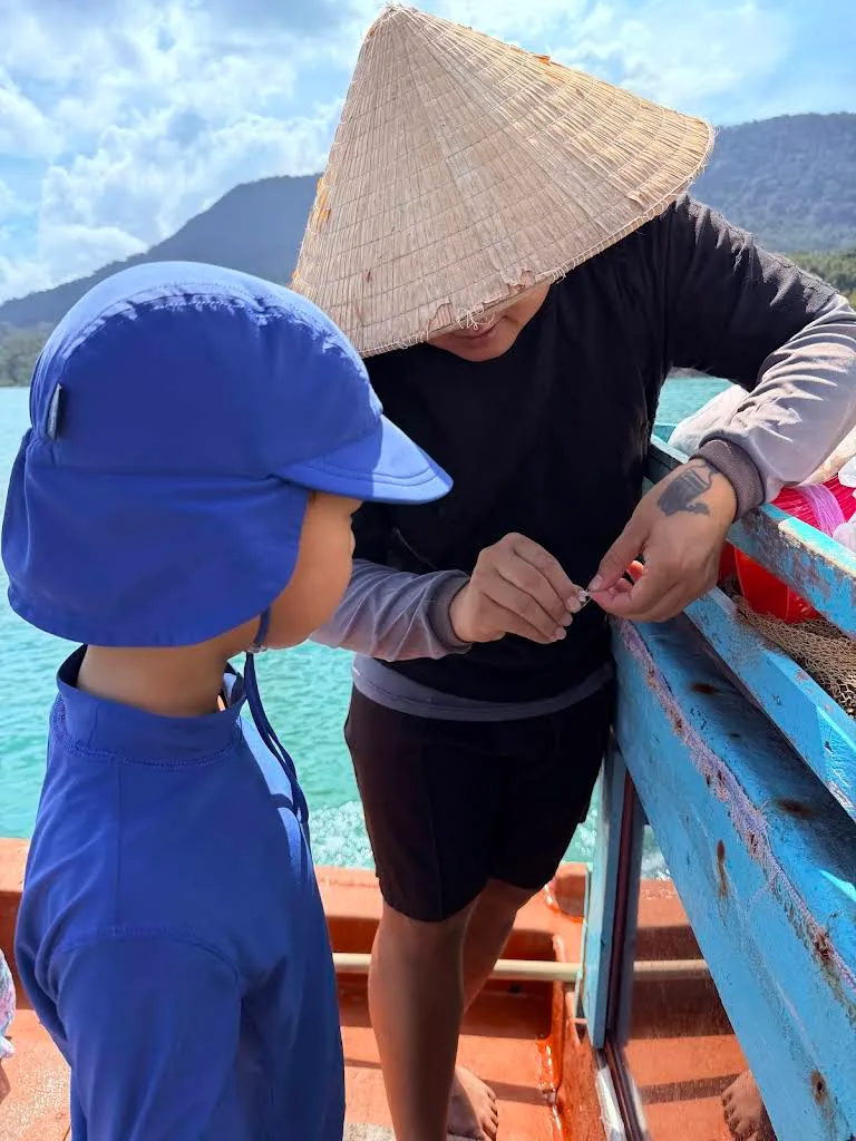 Man showing child how to bait