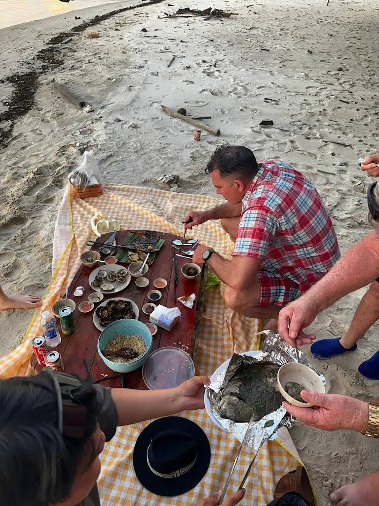 A group of people eating at starfish beach, phu quoc
