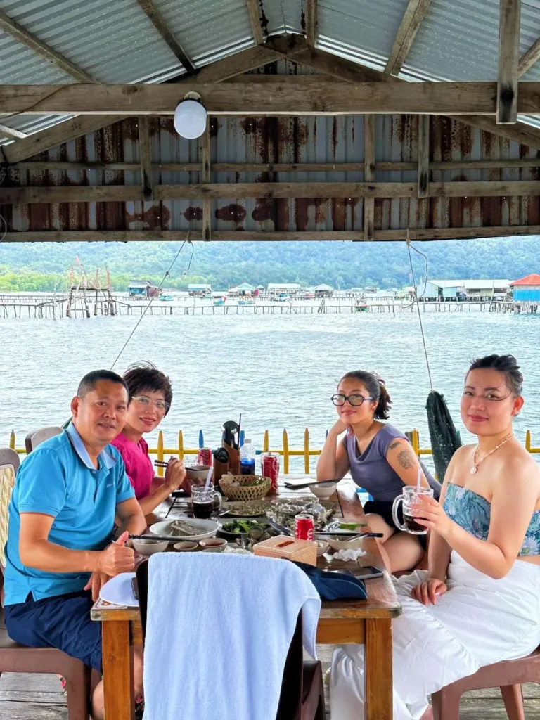 A family eating at a floating restaurant, near starfish beach, phu quoc